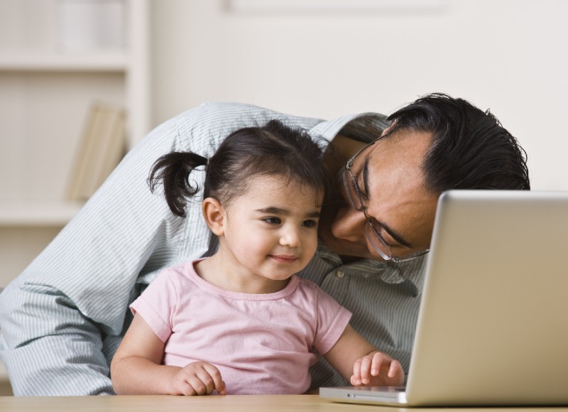 father and daughter on computer for telehealth call